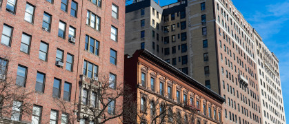 Row of Colorful Old Brick Residential Buildings and Skyscrapers in Morningside Heights of New York City